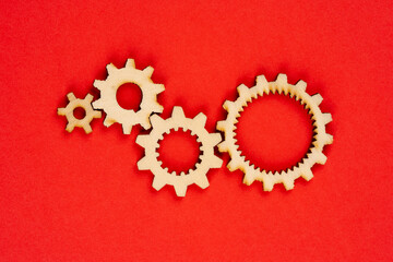 Wooden cogwheels on red background