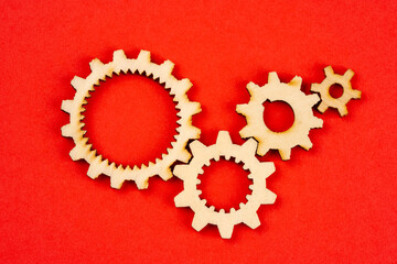 Wooden cogwheels on red background