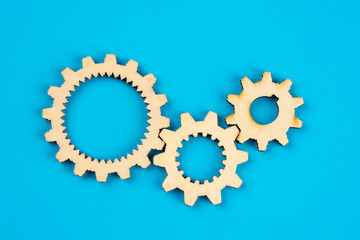 Wooden cogwheels on blue background 