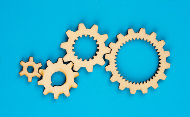Wooden cogwheels on blue background 