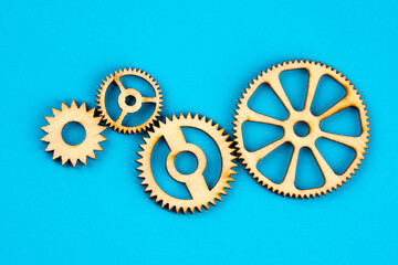 Wooden cogwheels on blue background 