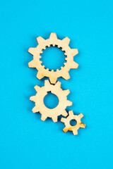 Wooden cogwheels on blue background 