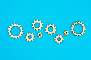 Wooden cogwheels on blue background 