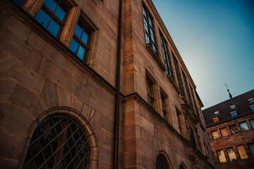 Old architectural building in Nuremberg city against blue bright sky. Cityscape