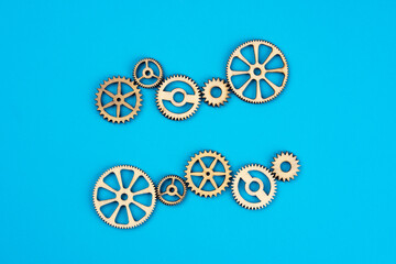 Wooden cogwheels on blue background 