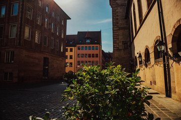 Old architectural building in Nuremberg city against blue bright sky. Cityscape