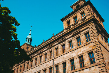 Old architectural building in Nuremberg city against blue bright sky. Cityscape