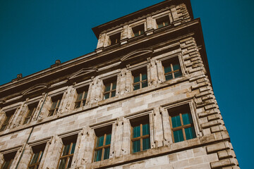 Old architectural building in Nuremberg city against blue bright sky. Cityscape