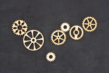  Wooden cogwheels on black background