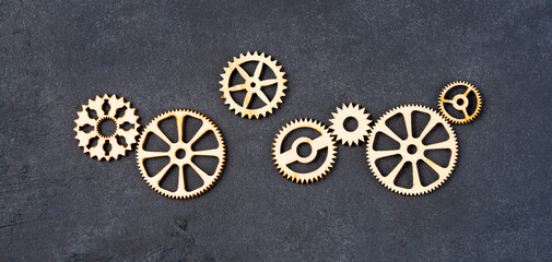  Wooden cogwheels on black background