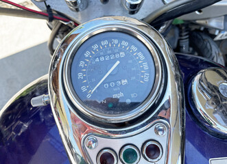 Close up of a round motorcycle speedometer