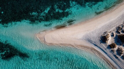 Pristine white sand beach meets turquoise ocean. Aerial view of a secluded cove
