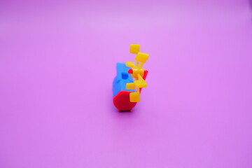 A colorful plastic whistle toy featuring a rotating yellow pinwheel on its tail. The whistle has a...