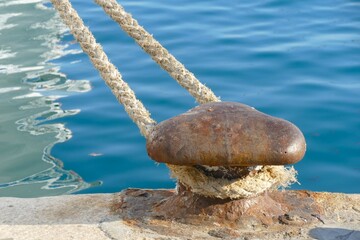 Iron marine mooring bollard for the boat by the blue sea nautical background