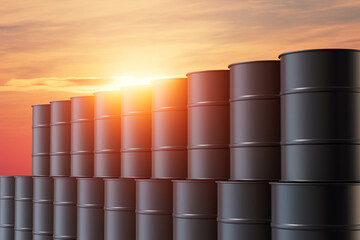 A stack of black barrels with the sun shining on them