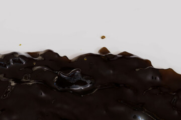 A brown liquid is dripping from a container