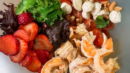 Luscious shrimp tango with strawberries and mozzarella in a whimsical fusion salad, perfect for...