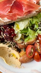 Crimson prosciutto crowns rustic sourdough, while salad whispers harvest blessings and...