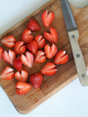 Strawberry dessert in the form of hearts on a cutting board