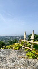 Sunlit stone bench overlooking lush valleys, ideal for imaginative Lepidopterist Day dreams or...