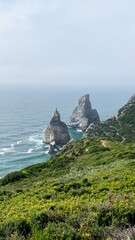 Majestic sea stacks pierce the misty Atlantic, evoking Fete de la Mer's maritime spirit and Gaia's...