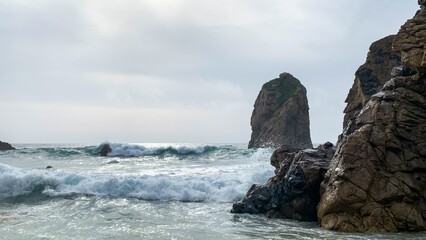 Waves crash against mystical sea stacks, evoking rugged serenity, reminiscent of Celtic Samhain and...
