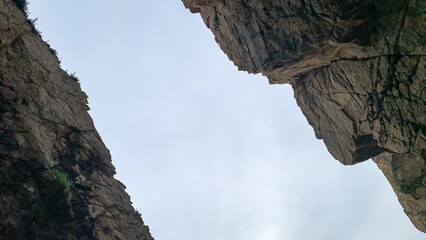 Craggy rock abyss embraces the sky, invoking a daring Ulysses journey, perfect for Cliffs of Moher Day and Solstice revelry