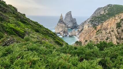 Craggy cliffs embrace the azure waves, echoing tales of intrepid explorers; perfect for National Geography Week or Coastal Cleanup Day