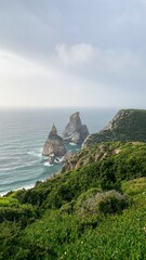 Mystical sea stacks tower over lush emerald cliffs, evoking Celtic folklore and the enchanting Imbolc festival celebrations
