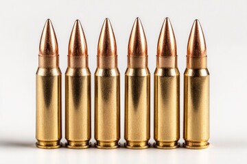 Six bullets stand upright in a row goldcolored and pointed against a white background