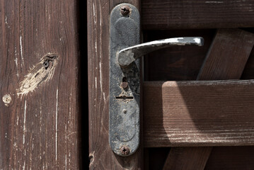 old vintage door handle and lock on wooden door