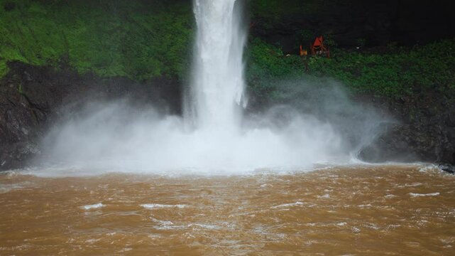 4K Closeup Slow motion shot of Devkund waterfall falling above the pool of the water at Raigad district in Maharashtra, India. Fog rises due to the striking of forceful waterfall in the pool. 