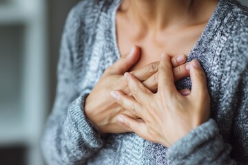 Woman with chest pain, touching her heart area