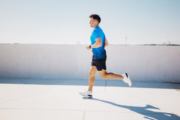 Jogger enjoying a sunny day while running on an open rooftop in a vibrant cityscape