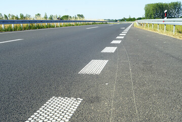 Highway infrastructure and traffic control innovations in Serbia: modern asphalt road with raised...