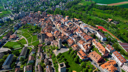 A panoramic aerial view around the old town of the city Orbe in Switzerland on a sunny spring noon