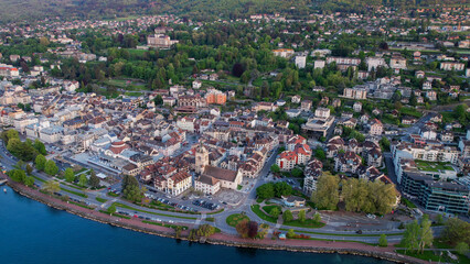 A panoramic aerial view around the old town of the city Evian-les-Bains in France on a sunny spring...