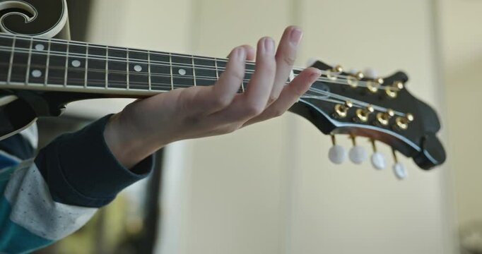 Caucasian Kid Play Mandolin at Home. European Boy Practice Music 4K 10-bit