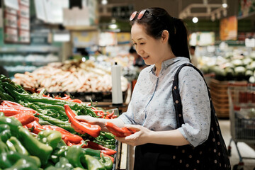 Woman Shopping for Peppers at Grocery Store