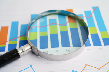 Magnifying glass on charts graphs paper. Financial development, Banking Account, Statistics, Investment Analytic research data economy.