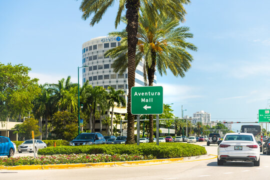 Aventura, USA - April 30, 2022: Aventura shopping mall sign with cityscape view on Collins avenue street road by Miami Florida