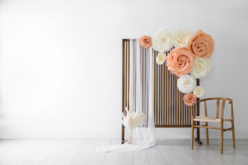 Photo zone with beautiful floral decor in studio