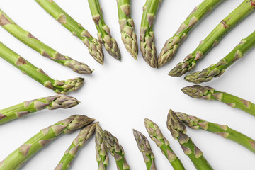 Frame of raw asparagus on white background, flat lay. Space for text