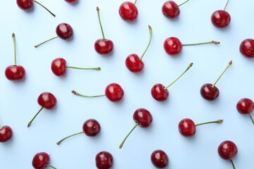 Fresh ripe cherries on light background, flat lay