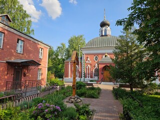 Brick building with a large dome on top. The building is surrounded by trees and has a courtyard Old Believer Church