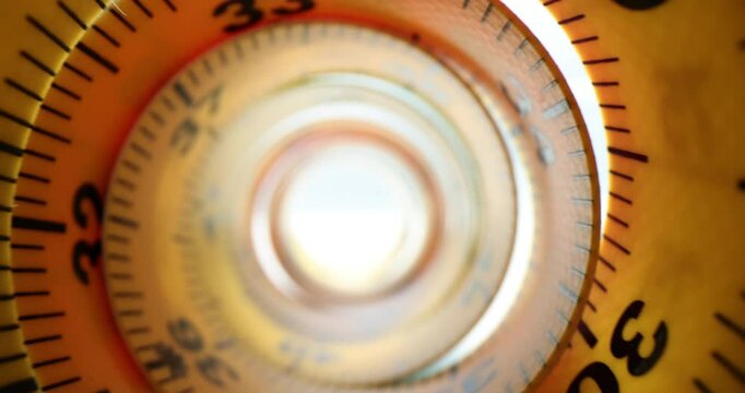 Compact yellow measuring tape rolled up creating circular tunnel with light at end. Symbol of measurement precision tailoring and path towards goal