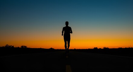 Fototapeta premium Solitary Runner Silhouetted Against Vibrant Sunset