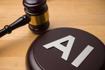 AI artificial intelligence alphabet and hammer judge gavel on wooden table background. Artificial...