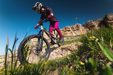 Cyclist man on mountain bike outdoors. Male tourist riding bicycle on grassy trail in mountains...