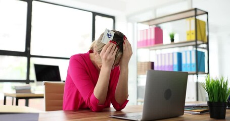 Lady office worker looks stressed while trying to make online payment with credit card. Financial problems with transaction on laptop in modern office - Powered by Adobe